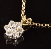 An 18ct gold pendant set with seven diamonds in a cluster, each diamond approximately 0.1ct (1.3g)