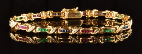 An 18k gold bracelet set with calibre cut emeralds, rubies and sapphires separated by cross sections