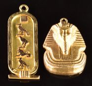 An 18k gold Egyptian pendant with hieroglyphic decoration and an 18k gold charm / pendant in the