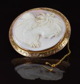 A 9ct gold brooch with scrolling decoration set with a coral cameo of a young woman, 28.5g, 5 x 5.