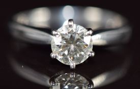 A platinum ring set with a round cut diamond of approximately 0.94ct, 4.4g, size O