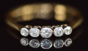 An 18ct gold ring set with five diamonds in a platinum setting, 1.4g, size M