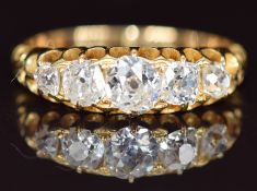 A c1900 18ct gold ring set with five old cut diamonds, the centre diamond approximately 0.35ct, 2.
