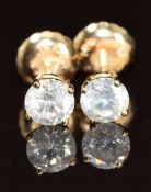 A pair of 14k gold earrings each set with a round cut diamond of approximately 0.25ct, 0.6g, with