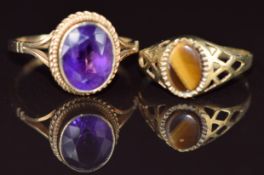 A 9ct gold ring set with an oval cut amethyst (size P) and a 9ct gold ring set with tiger's eye (
