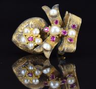 Victorian brooch set with rubies and split pearls, verso a glass locket compartment, 4.9g, 2.5cm