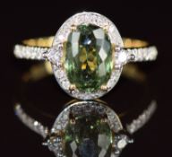 An 18k gold ring set with an oval cut demantoid garnet of approximately 3ct surrounded by