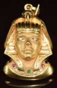 An 18k gold pendant in the form of a pharaoh set with sapphires, rubies, an emerald, and cubic
