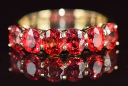 A 14k gold ring set with six oval cut rubies from Tanzania totalling approximately 2.4ct, 3.3g, size