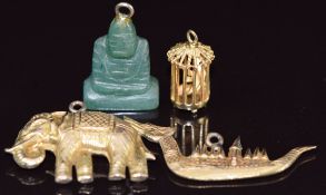 A 14k gold charm in the form of a bird cage (1.8g), two gilt charms / pendants, one in the form of