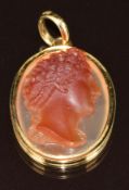 A c1900 18ct gold pendant set with a hardstone agate cameo depicting a young man, mount marked JR,