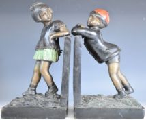 Pair of spelter bookends formed as a boy and girl, height 38cm