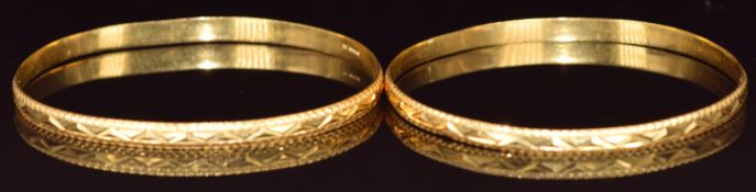 Two 22ct gold bangles with cut out decoration, 26.6g, 6cm