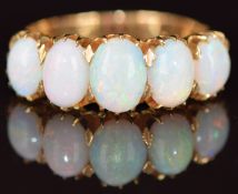A c1920 18ct gold ring set with five opal cabochons, 4.3g, size L/M