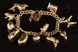 A 9ct gold charm bracelet with eleven 9ct gold charms including rugby ball, boot, horse, etc, 20.2g,