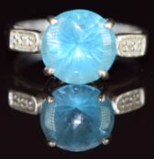 A 9ct white gold ring set with a round cut topaz and diamonds, 4.2g, size M