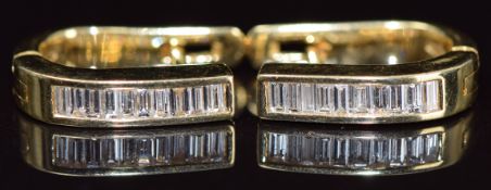 A pair of 18k gold and diamond earrings set with baguette cut diamonds, 5.8g