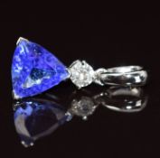 A 14k white gold pendant set with a 2.1ct trilliant cut tanzanite and a round cut diamond of