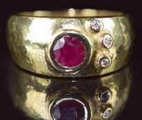 An 18ct gold ring set with a round cut ruby of approximately 0.35ct and three diamonds, 6g, size L