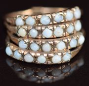 A 9ct gold ring made up of four bands, each set with six opals, 3.5g, size L