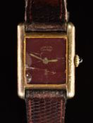 Must de Cartier silver gilt ladies wristwatch with maroon dial, gold hands, sapphire set crown and