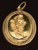 A yellow metal locket with floral decoration, tests as 18k gold, 9.9g, 3.8 x 3cm