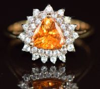 A 9ct gold ring set with a trilliant cut spessartite garnet surrounded by white zircons, 2.2g,