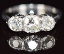 A platinum ring set with three old cut diamonds of approximately 0.5ct, 0.25ct & 0.3ct, 2.6g, size L