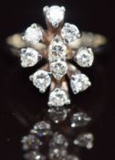 A 14k white gold ring set with ten round cut diamonds, each approximately 0.08ct in a cluster, 3.1g,