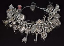 A silver charm bracelet with thirty silver charms including keys, Nuno flower opening to reveal a
