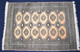 Turkoman rug with multiple borders and a central blue and white geometric cartouche