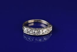 An 18ct white gold half eternity ring set with seven graduated old cut diamonds measuring from 0.
