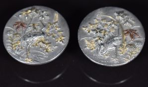 A pair of Japanese Meiji period silver buttons with embossed heron and foliage decoration, 18.6g