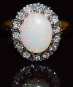 An 18ct gold ring set with an oval cut opal surrounded by diamonds, 4g, size L