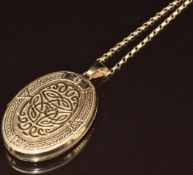 A 9ct gold locket with embossed Celtic decoration (4.4cm) on 9ct gold chain, 8.8g, 60cm