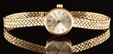 Garrard 9ct gold ladies wristwatch with gold hands and baton hour markers, silver dial and quartz