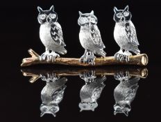 A 9ct gold bi-coloured brooch in the form of three owls set with diamond eyes, 6.1g, 4 x 1.8cm