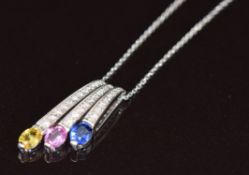 An 18k white gold necklace set with an oval cut yellow, pink and blue sapphire, each approximately