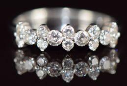 A 9k white gold ring set with fourteen diamonds, totalling approximately 0.49ct, 1.6g, size L