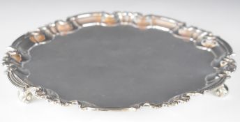 Victorian hallmarked silver salver with shaped edge, raised on three scroll feet, London 1894, maker
