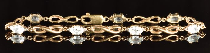 A 9ct gold bracelet set with oval cut topaz, 6.4g, 19cm