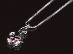 An 18k white gold pendant set with diamonds and a purple flower, on 18k white gold chain, 4.8g, 44cm
