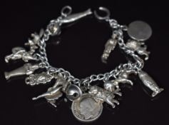 A silver charm bracelet with fourteen silver charms including donkey, dog, fox, fish, etc, 48g