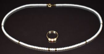 A 9ct gold ring set with coral and pearls (2g, size L) and a cultured pearl necklace with 18k gold