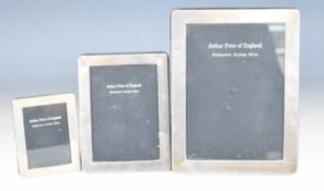 Arthur Price of England graduated set of three hallmarked silver photograph frames with easel backs,