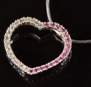 A 9ct white gold heart pendant set with diamonds and rubies, the total diamond weight