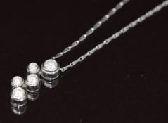 Tiffany & Co platinum pendant set with five round cut diamonds, the total diamond weight