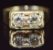 An 18ct gold ring set with two round cut diamonds