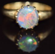 An 18ct gold ring set with a round black opal cabochon, Birmingham 1911, 3.1g, size M
