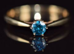 A 9k gold ring set with a round cut blue diamond of approximately 0.26ct, 1.1g, size N